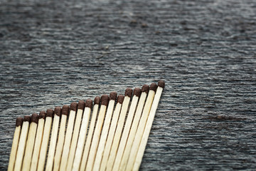 row of matches lie on a gray background, space for text