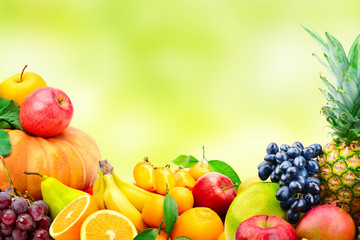Large collection of fruits and vegetables on blur green background.