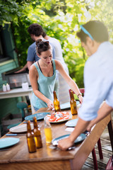 Group of students preparing bbq on terrace
