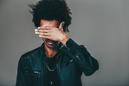 man making facepalm gesture, covering eyes while feeling ashamed