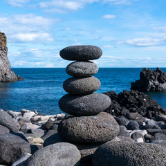 Fototapeta na wymiar Five balance stone on ocean coast in south of Iceland