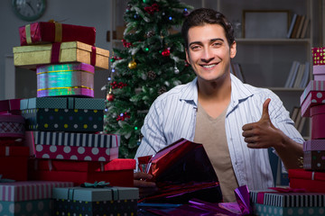 Man with many christmas gifts in boxes
