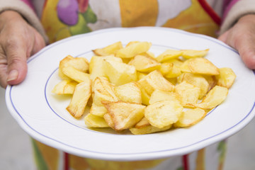 woman holding in hands dish of potato chips