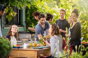 Group of students having fun while they prepare a bbq