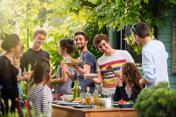 Group of students having fun while they prepare a bbq