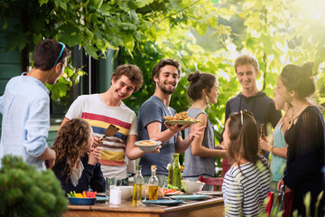 Group of students having fun while they prepare a bbq
