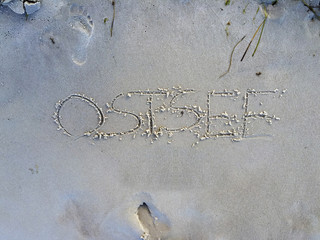 the word ostsee written in the sand
