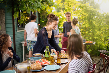 Group of students having fun while they prepare a bbq