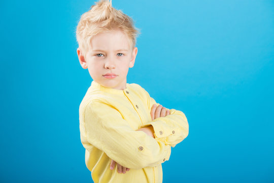 Charming Handsome young man in casual wear keeping arms crossed and smiling