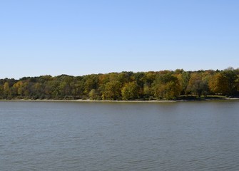  shoreline the Fanshawe reservoir lake lined with with colorful trees in Autumn ,  in London, Ontario Canada