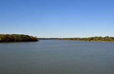  shoreline the Fanshawe reservoir lake lined with with colorful trees in Autumn ,  in London, Ontario Canada