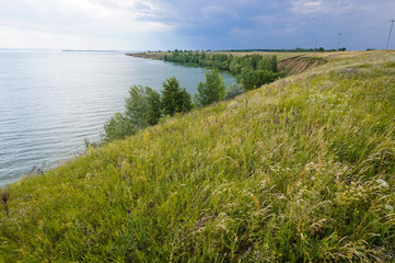Fototapeta na wymiar The shore of the Volga in the summer. Beautiful view, the high bank of the Volga River in Russia in the summer.