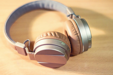 Bluetooth headphone on wooden background