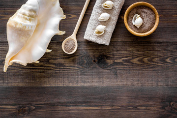 Sea cosmetics and shell from dead sea for homemade spa wooden background top view mock up