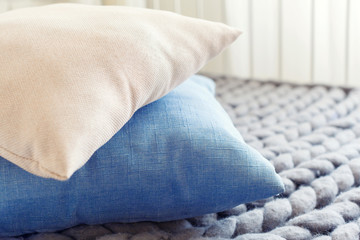 Fototapeta na wymiar Grey knit giant plaid with pillows
