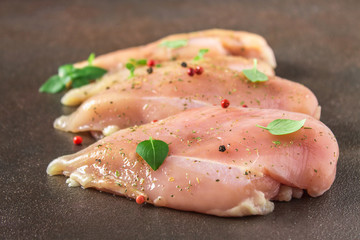 Raw fillet of chicken on rusty background. Meat ingredients for cooking.