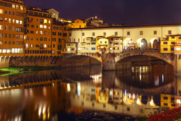 River Arno and famous bridge Ponte Vecchio at night in Florence, Tuscany, Italy
