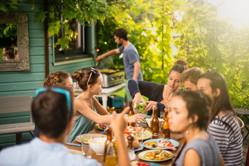 Group of students having fun while they prepare a bbq