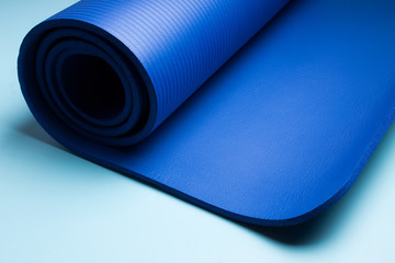 Blue yoga mat . Equipment for yoga. Concept healthy lifestyle and sport.
