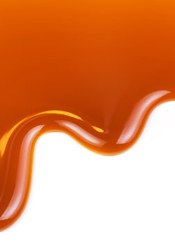 Pouring caramel sauce isolated on white background. Golden Butterscotch toffee caramel liquid spot.