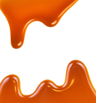 Sweet caramel sauce isolated on white background close up. Golden Butterscotch toffee caramel liquid .