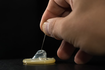 condom that is worn by a needle