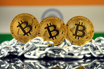 Physical version of Bitcoin (new virtual money), chain and India Flag. Conceptual image for investors in cryptocurrency and Blockchain Technology in India.