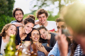 A group of students pose while a friend takes a picture