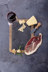 Prosciutto served with cheese and wine