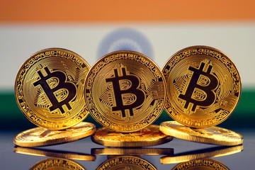 Physical version of Bitcoin (new virtual money) and India Flag. Conceptual image for investors in cryptocurrency and Blockchain Technology in India.