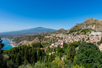 Taormina with the Etna volcano in the background seen from Greek theater  , Sicily, Italy