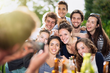 A group of students pose while a friend takes a picture