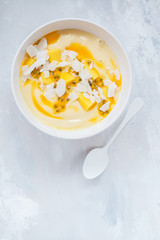 Mango smoothie bowl with coconut and passion fruit.