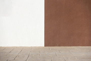 White and brown plastered wall and pavement as background