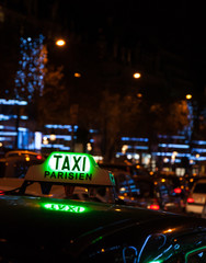 A Parisian taxi for hire at Avenue des Champs-Elysees decorated Christmas illumination.