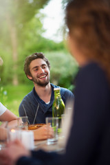 Group of young people having fun outside, focus on a young man
