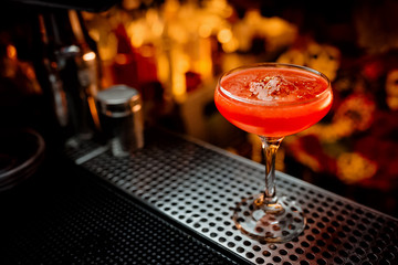 Delicious red cocktail on dark background bar party