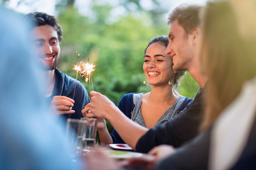 a group of students having fun while lighting sparkling sticks