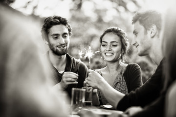 a group of students having fun while lighting sparkling sticks