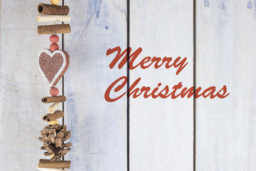 Christmas decoration on a wooden background with text in English "Merry Christmas"