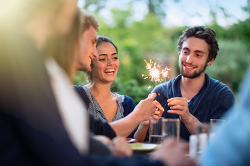 a group of students having fun while lighting sparkling sticks