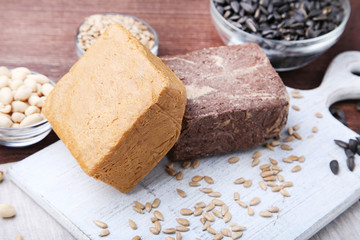 Tasty halva with seeds on cutting board