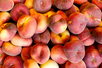 Nectarines in the store. A lot of nectarines close-up. Ripe nectarines. Selective focus 
