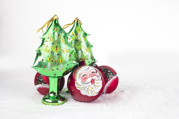 Group of colorful Christmas ball with drawing of Santa Claus and trees on a white snow background