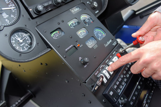 Man manipulating controls in cockpit