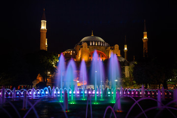 Fototapeta na wymiar View of colorful night view of the Hagia Sophia with a fountain illumination. Istanbul. Turkey.