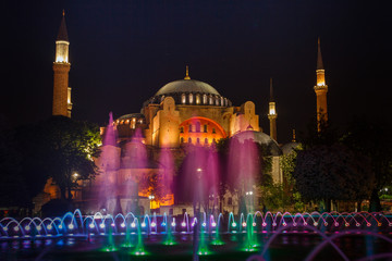 Fototapeta na wymiar View of colorful night view of the Hagia Sophia with a fountain illumination. Istanbul. Turkey.