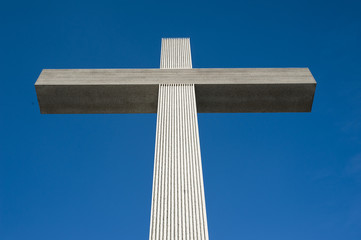 Catholic cross on the blue sky background