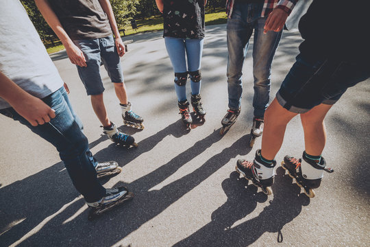 Legs wearing roller skating shoe. Outdoors. Skatepark