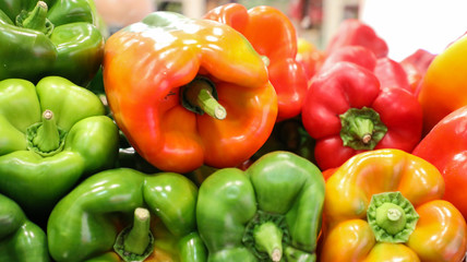 Green, orange, red and yellow bell peppers.